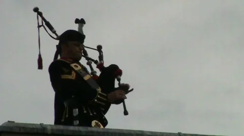Rooftop piper with salute at end Video stock 460285