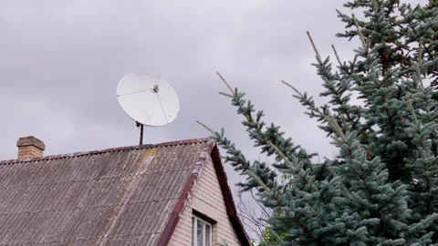 Rooftop satellite dish for television reception attached to brick chimney next Vídeo Stock 344356676