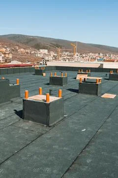 Rooftop scene shows several construction markers placed on flat surfaces. In  Stock Photos