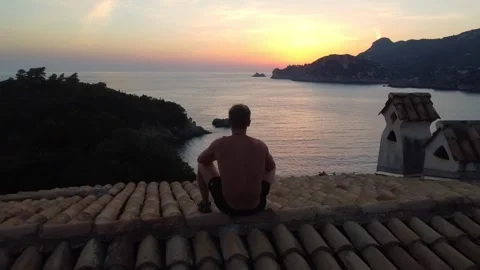 Rooftop Silhouette Watching Sunset Over the Ionian Sea, Corfu Stock Footage 337732225