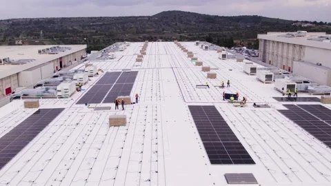 Rooftop solar installation workers downward move with upward gimbal Stock Footage 331196144
