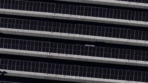Rooftop solar panel array forming horizontal photovoltaic grid pattern, top Video stock 331071402