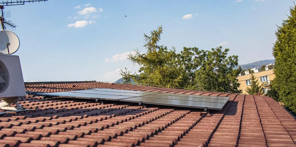 Rooftop Solar Panel Array on Residential Building Stock Photos