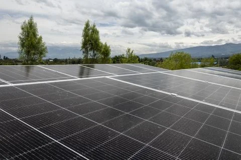 Rooftop solar panel installation generating clean electricity Stock Photos