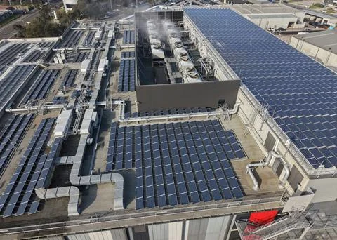 Rooftop solar panels generating clean renewable energy Stock Photos