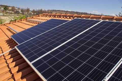 Rooftop solar panels installed on one side of a slanted roof Stock Photos