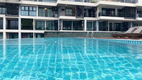 Rooftop swimming pool with clear blue water reflecting sunlight Stock Footage 330767594