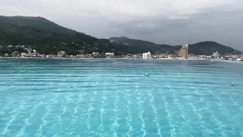 Rooftop swimming pool with clear blue water reflecting clouds and buildings Stock Footage 330767629