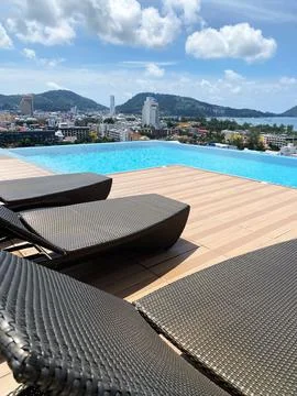 Rooftop swimming pool with infinity edge overlooking a cityscape, featuring Stock Photos