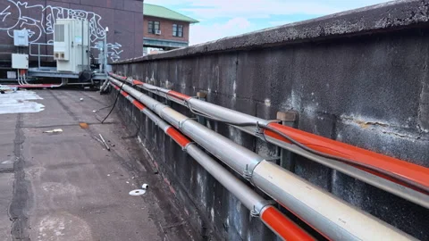 Rooftop Utility Conduits Along Parapet with Urban View, NY, USA 03/12,2026 Video stock 330668070