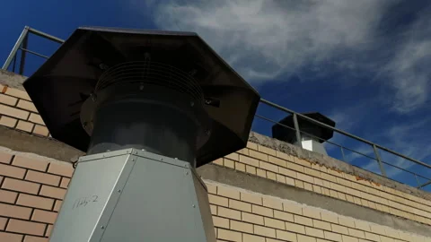 Rooftop ventilation exhaust units installed on brick building Stockbeeldmateriaal 347213838