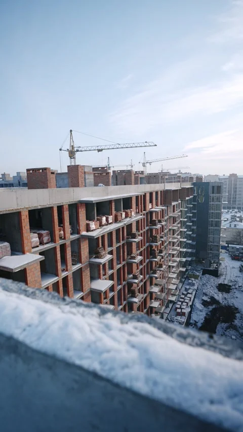 Rooftop view with crane and snow-covered city Stock Footage 327842321