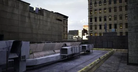 Rooftop view of urban landscape featuring buildings and air conditioning unit Ilustración de archivo