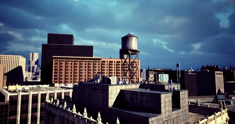 Rooftop view of urban skyline under dramatic clouds in late afternoon Stock Footage 318687901