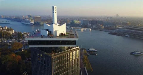 Rooftop viewing deck on a glass tower above a wide waterway Stock-Footage 71296132