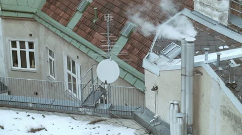 Rooftops 002 covered with snow with chimney smoke in vienna Stock Footage 45701505