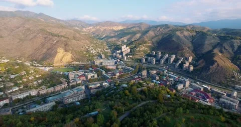 Rooftops and roads moving towards the green forest mountain Video stock 131739156