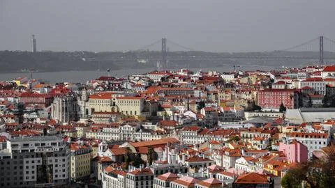 Rooftops with the bridge creating a line on the horizon of Lisbon Stock Photos