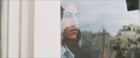 Rooftops reflection on the window with a young man on the backside Stock Footage 203586435