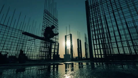 Rooftops at sunset with a worker constructing a framework Video stock 133766500