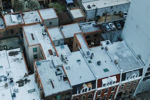 Rooftops of various buildings are visible from above, featuring flat surfaces Stock Photos
