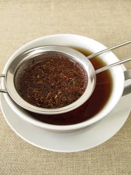 Rooibos tea in tea strainer Stock Photos