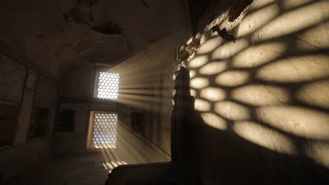 Room with a barred window, through which penetrate the light of the sun's rays Stock Footage 105300261
