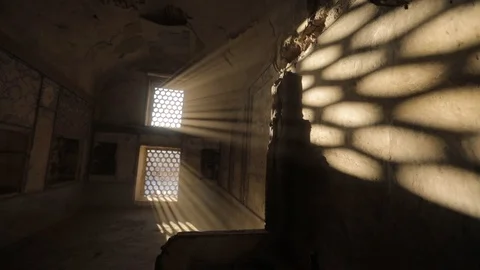 Room with a barred window, through which penetrate the light of the sun's rays Stock Footage 105300263