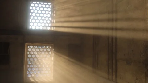 Room with a barred window, through which penetrate the light of the sun's rays Stock Footage 105300299