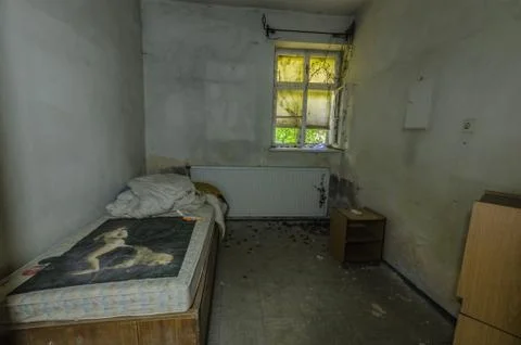 Room with bed in an abandoned building Stock Photos