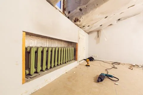 Room with central heating and heating adiator and construction tools on the Stock Photos
