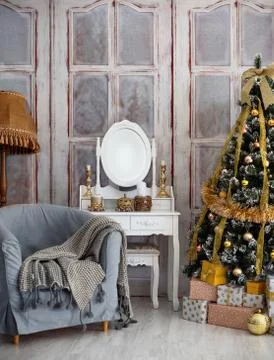 Room with a Christmas tree and a table with a mirror. Stock Photos