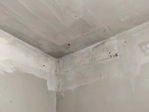 Room corner with paint marks and moisture stains Stock Photos