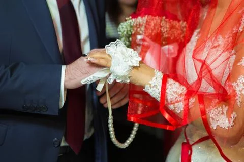 Room Dresses the Ring for the Bride, close-up. Newlyweds exchange rings, groo Stock Photos