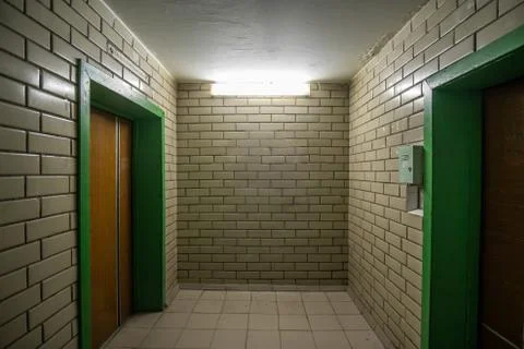 Room with elevators of a Soviet apartment building of the 80s, lined with gla Stock Photos