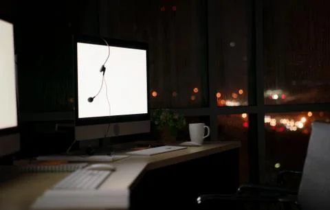 Room illuminated by a computer screen at night, no people,  Empty workplace p Stock Photos