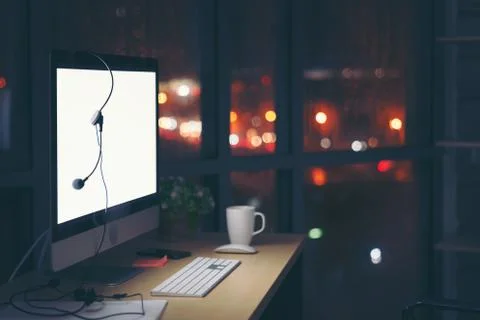 Room illuminated by a computer screen at night, no people,  Empty workplace p Stock Photos