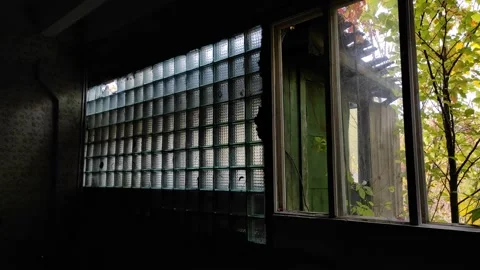 A room inside a building with broken windows and shabby walls. Video stock 219202388