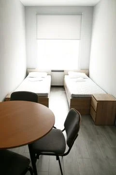 Room interior with minimalist design using natural wood headboard. Walls with Stock Photos