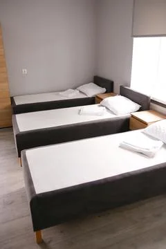 Room interior with minimalist design using natural wood headboard. Walls with Stock Photos