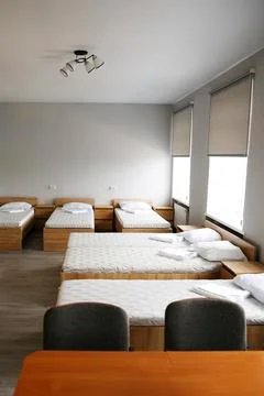 Room interior with minimalist design using natural wood headboard. Walls with Stock Photos