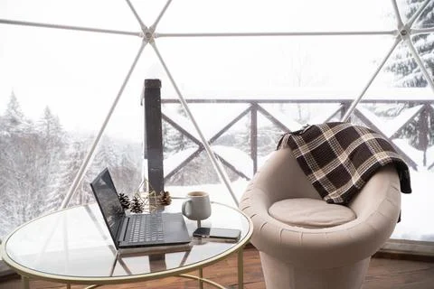 Room interior with panoramic windows. Table with laptop and cup of tea. Plaid Stock Photos