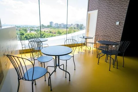 A room next to window with a view consists of a table and chair representin.. Stock Photos