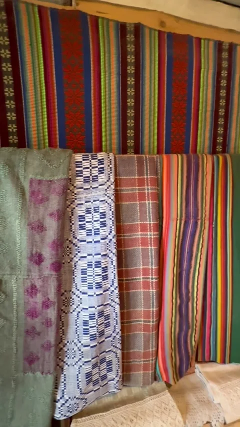 Room with patterned textiles hanging vertically, colorful interior decor and cul Stock Footage 334793846