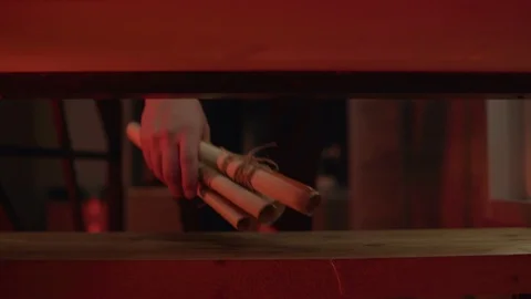 The room, on the shelf are paper scrolls. A man fits and takes them in hand. Stock Footage 108042586