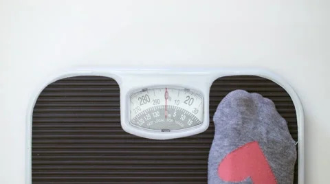 Room for Text and 115lbs - 52kg Woman Stepping on Bathroom Scale Stock Footage
