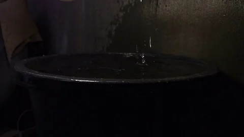 In the room there is a capacity in which rainwater enters Video stock 80034375