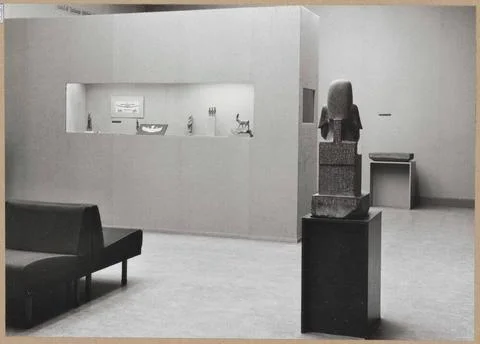 Room with two stone objects, a partition wall with a showcase filled with ... Stock Photos