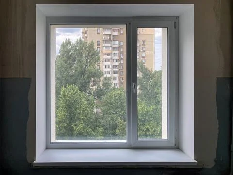 Room with two windows, one closed and one open Light-colored walls and floo.. Stock Photos