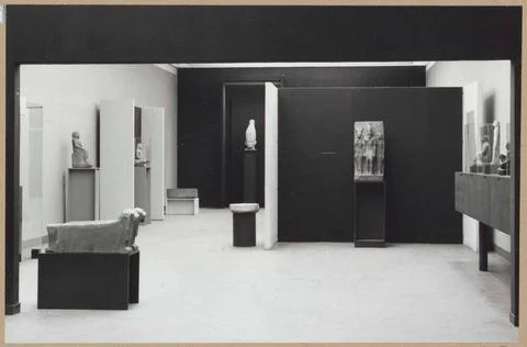 Room with various objects including a head and a picture of three people; ... Stock Photos